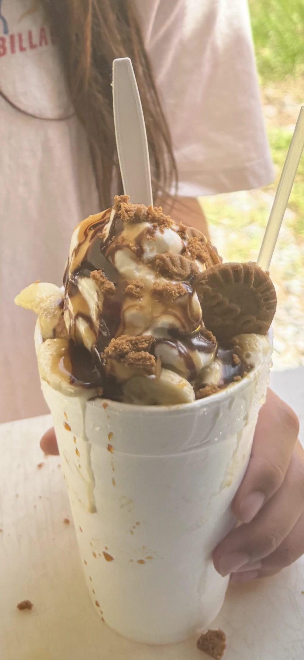 Stuffed specialty snowball drizzled with chocolate and cookie crumbles